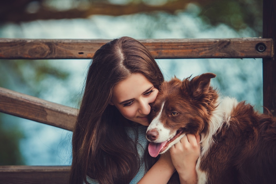 A girl hugs his dog